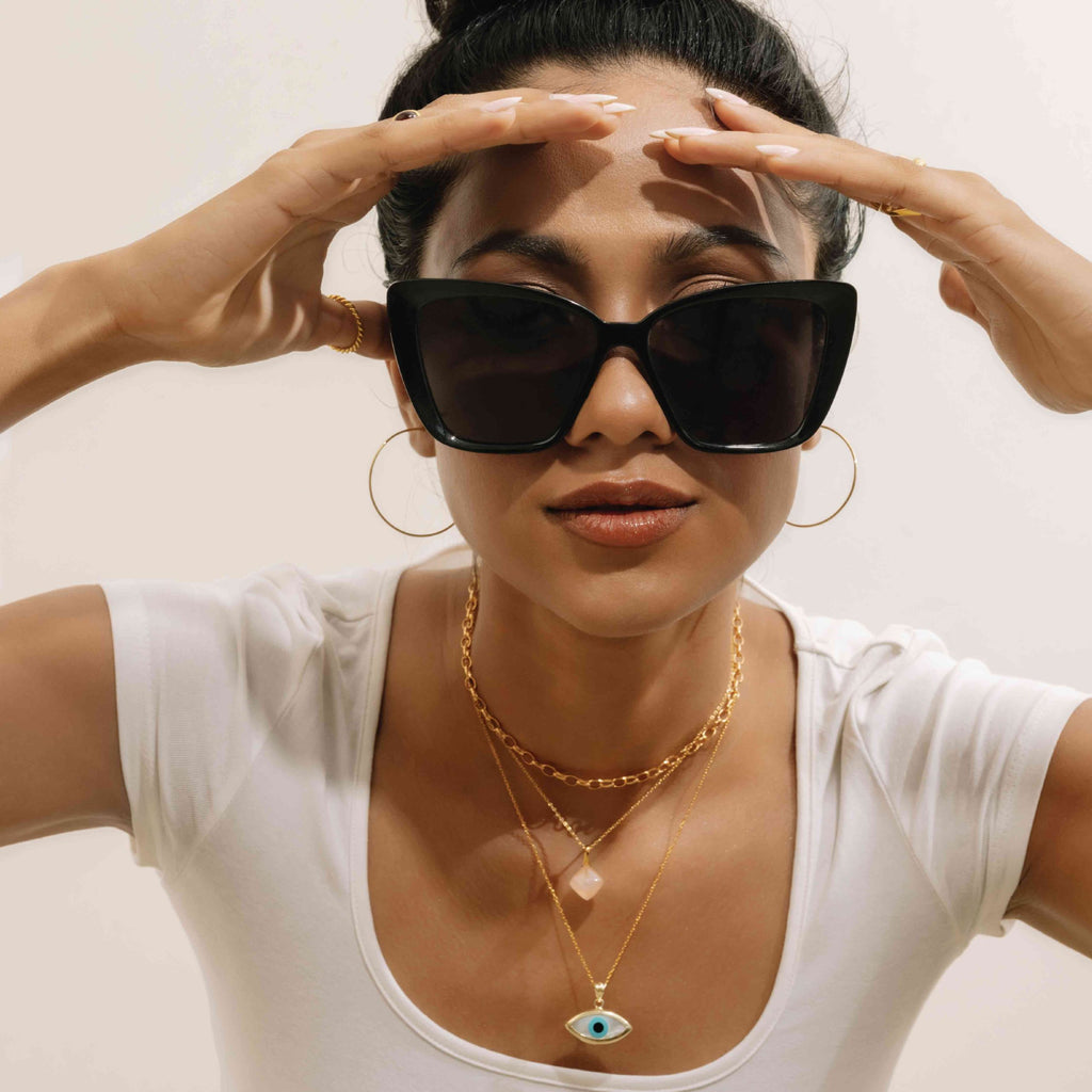 Model styling the 14kt Evil eye pendant from Stoned Jewelry